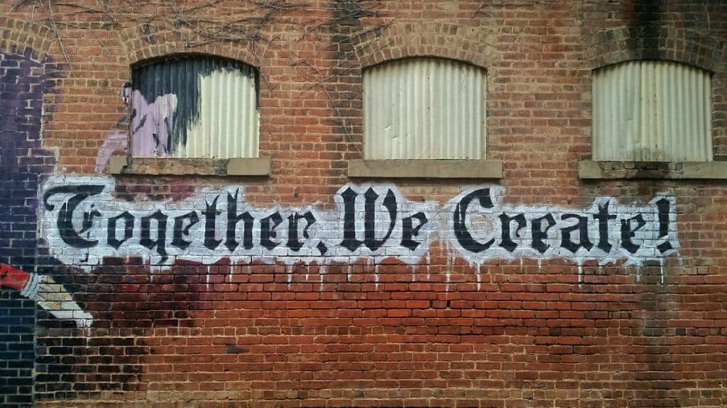 Together we create written on the side of a city building